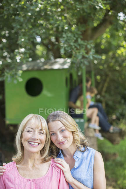 Мать и взрослая дочь улыбаются на открытом воздухе — стоковое фото