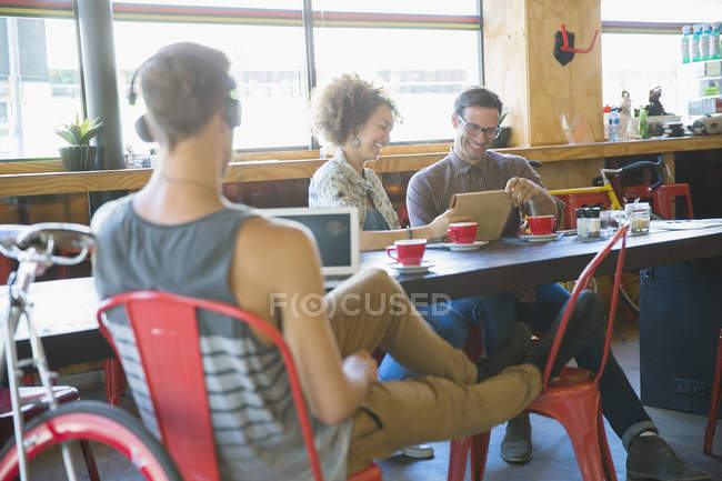 People using digital tablets in cafe — Stock Photo