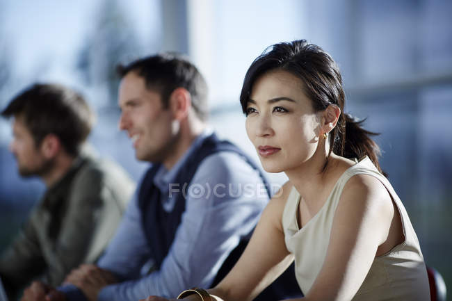 Successful adult business people sitting in meeting — Stock Photo