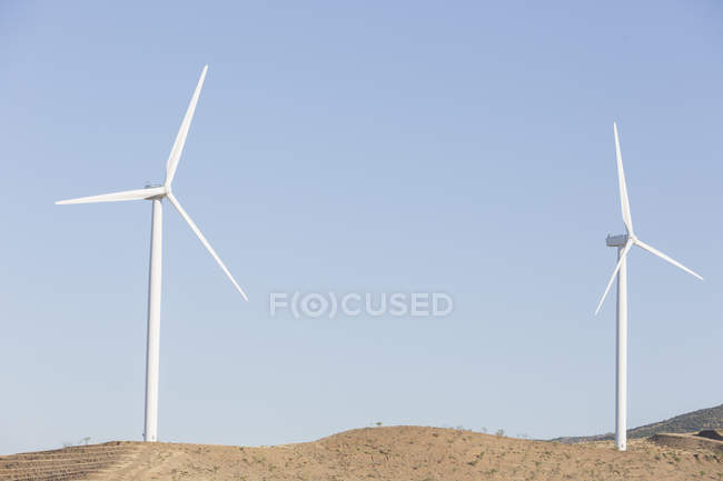 Wind turbines spinning in rural landscape — Stock Photo