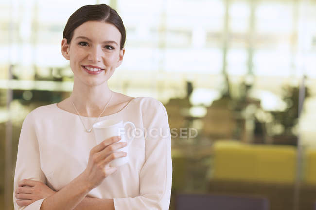 Бізнес-леді посміхається в офісі — стокове фото
