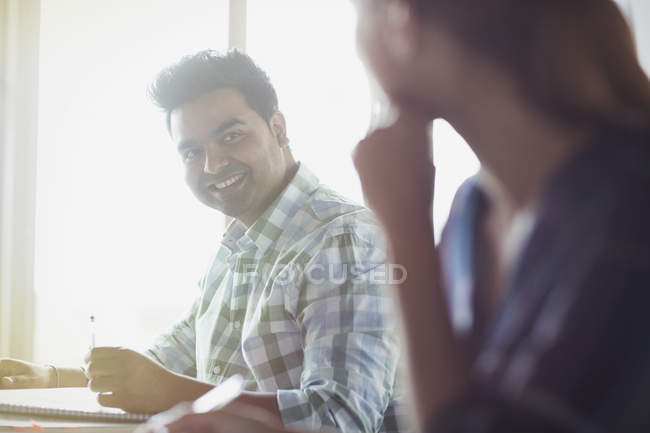 Smiling students talking in adult education classroom — Stock Photo