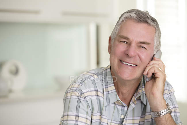 Close up of senior man talking on telephone — Stock Photo