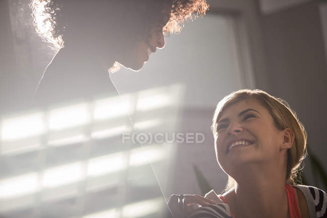 Happy businesswomen smiling in modern office — Stock Photo