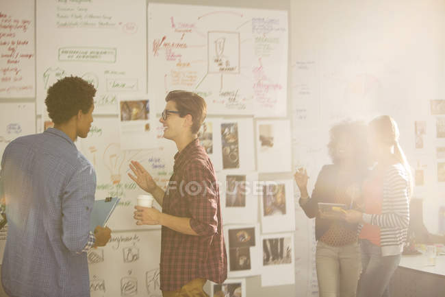 Business people looking at flow charts in meeting — Stock Photo