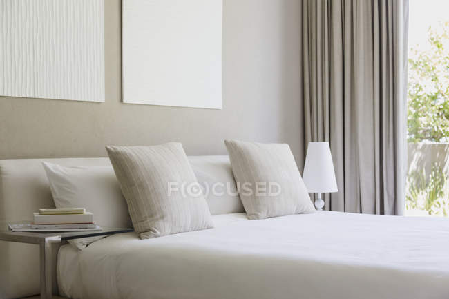 White bed in modern bedroom interior — Stock Photo
