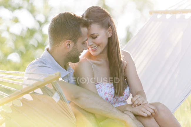 Affectueux jeune couple en hamac d'été — Photo de stock
