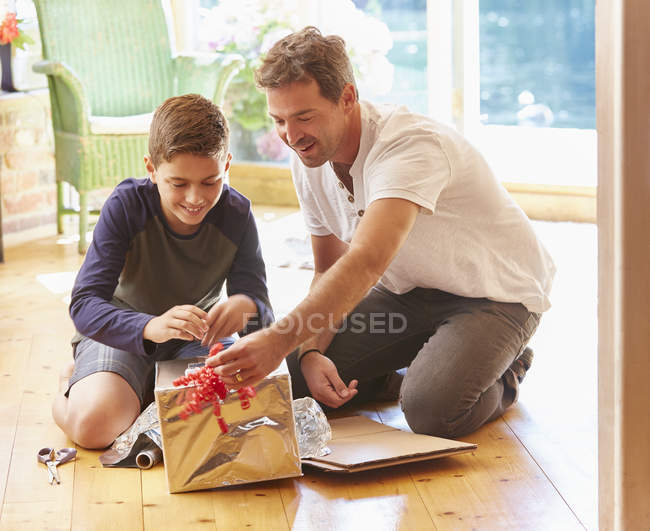 Father and son making robot costume — Stock Photo