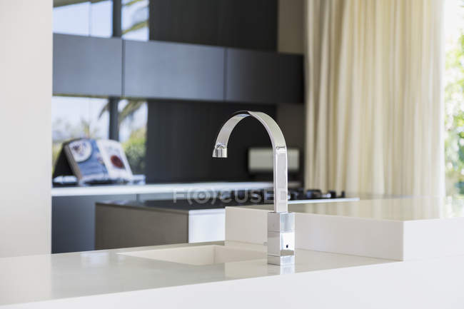 Faucet and sink in modern kitchen interior — Stock Photo