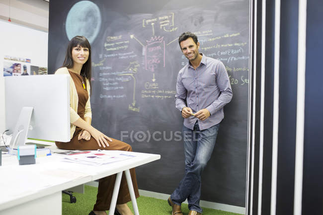 Business people smiling in modern office — Stock Photo