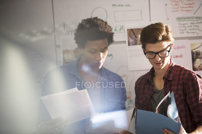 Young businessmen talking in modern office — Stock Photo