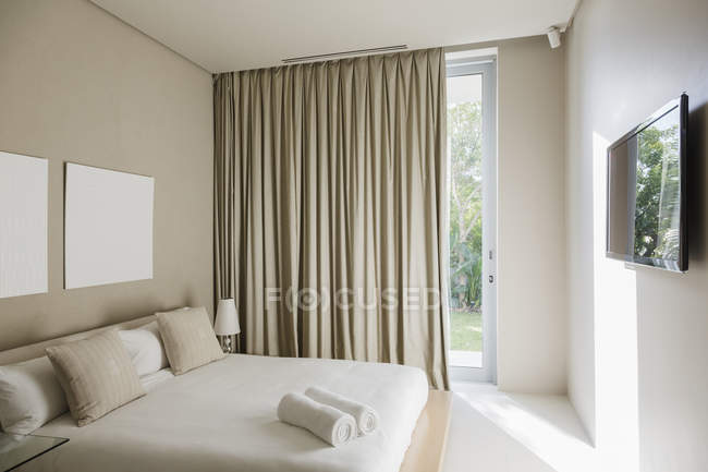 Curtains and bed in modern bedroom interior — Stock Photo