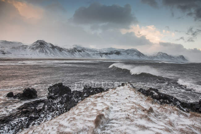 Cordilheira coberta de neve sobre o oceano frio, Budir, Snaefellsnes, Islândia — Fotografia de Stock