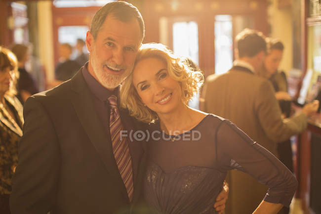 Portrait of well dressed couple in theater lobby — Stock Photo