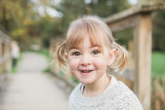 Portrait smiling toddler girl with pigtails — Stock Photo