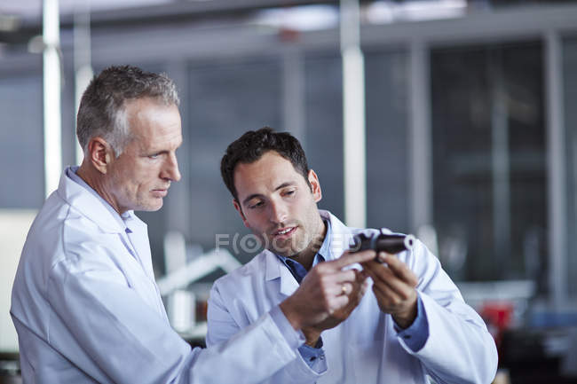 Successful adult scientists working in laboratory — Stock Photo