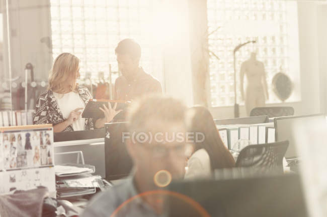 Fashion designers meeting in sunny office — Stock Photo