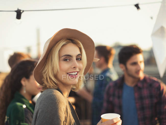 Retrato sonriente joven mujer disfrutando de la fiesta en la azotea - foto de stock