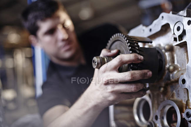 Close up mechanic fixing part in auto repair shop — Stock Photo