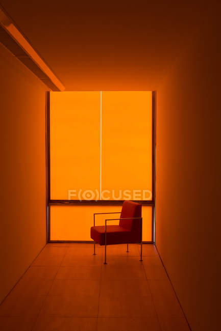 Stuhl am Fenster im orangefarbenen Büro — Stockfoto