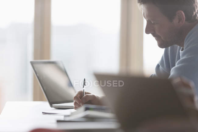 Focused businessman taking notes in meeting — Stock Photo