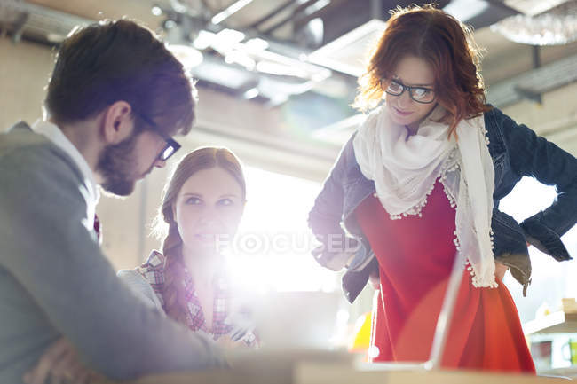 Casual business people working in sunny office — Stock Photo