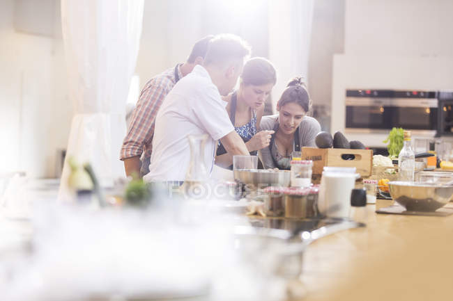 Teacher and students in cooking class kitchen — Stock Photo