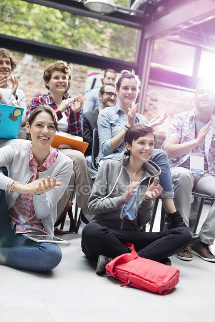 Smiling audience clapping at conference — Stock Photo