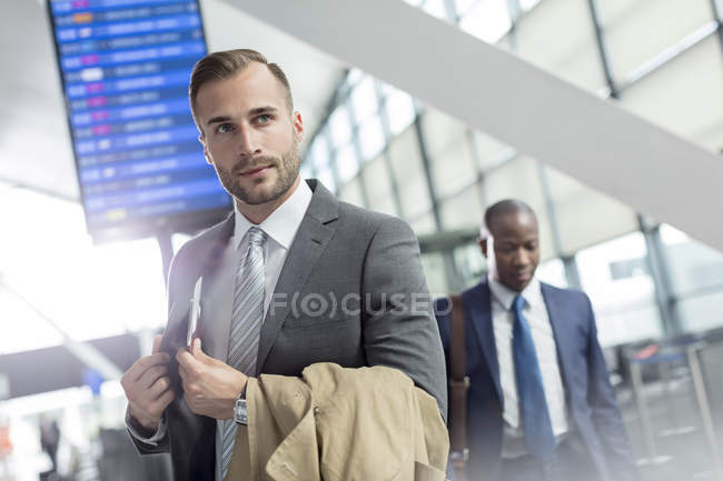 Businessman in airport concourse — Stock Photo