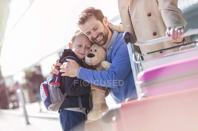Отец и сын обнимаются возле аэропорта — стоковое фото