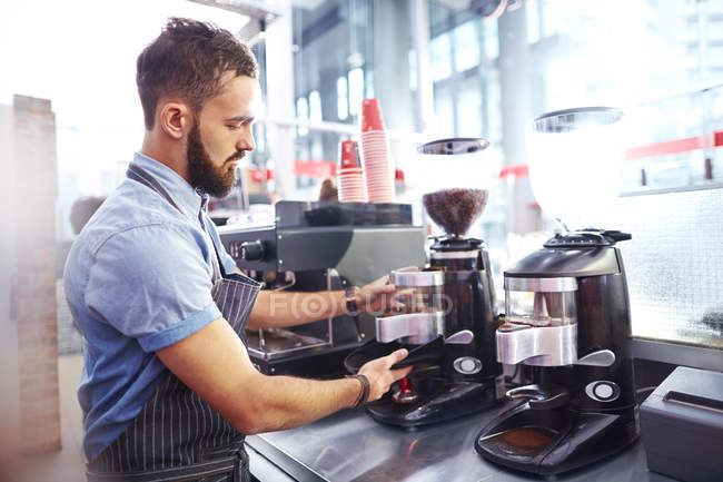 Barista making coffee in modern cafe — Stock Photo