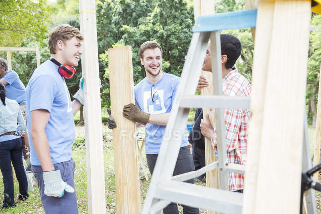 Volunteers talking at construction site — Stock Photo
