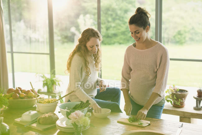 Pregnant women preparing food — Stock Photo