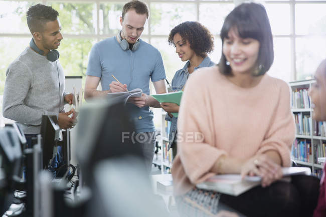 College students studying in library together — Stock Photo