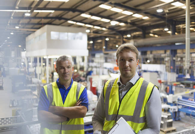 Portrait confident supervisors in steel factory — Stock Photo