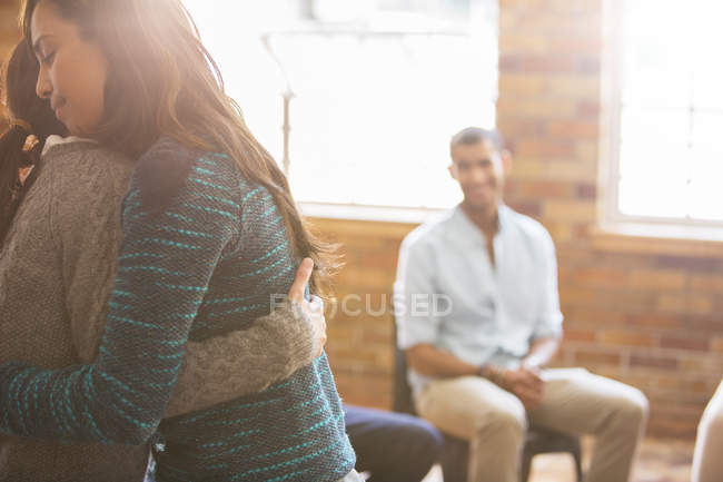 Women hugging at group therapy session — Stock Photo