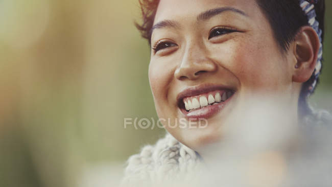 Close up portrait smiling woman looking away — Stock Photo