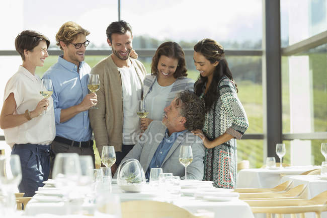 Friends drinking wine in winery dining room — Stock Photo