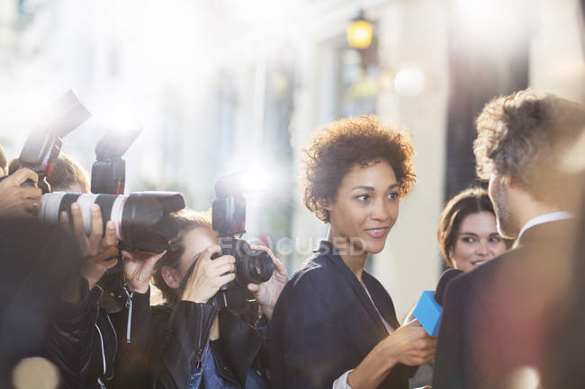 Celebrity being interviewed and photographed by paparazzi at event — Stock Photo