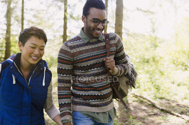 Couple holding hands hiking in woods — Stock Photo