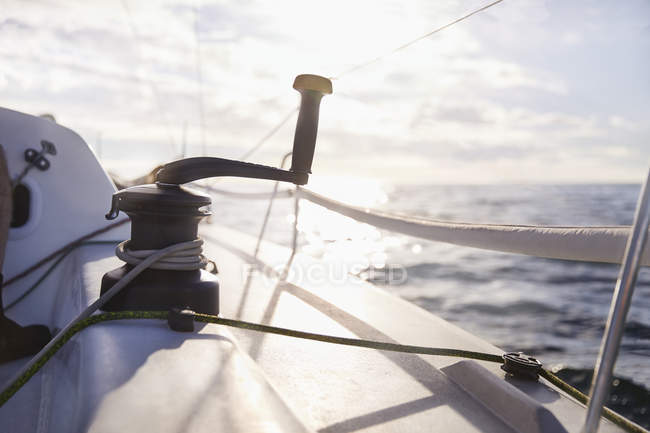 Sailing cable winch and handle on sailboat — Stock Photo