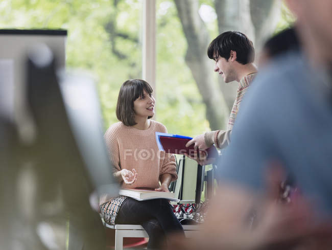 College students discussing homework together — Stock Photo