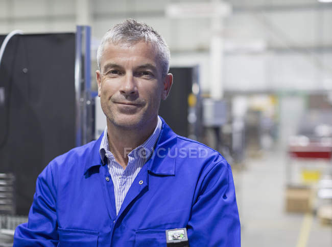 Portrait smiling worker in steel factory — Stock Photo