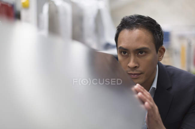Focused manager inspecting steel in steel factory — Stock Photo