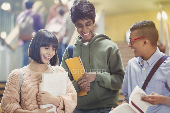 College students discussing homework in stairway — Stock Photo