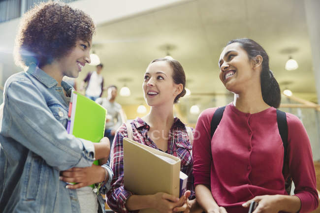 College students smiling and talking together — Stock Photo