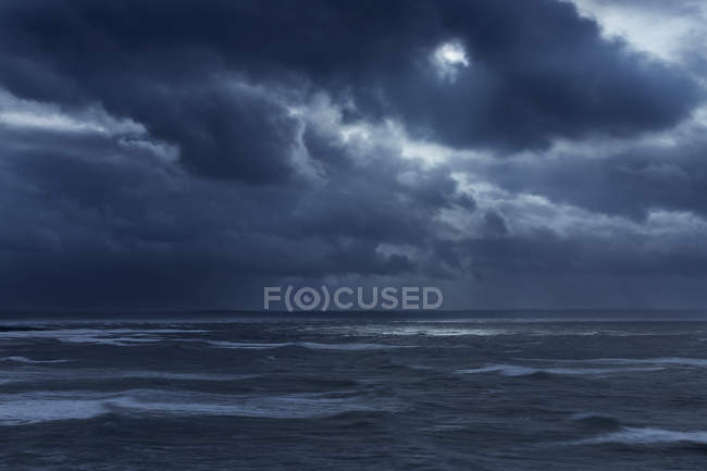 Dark clouds in overcast sky over stormy ocean, Devon, United Kingdom — Stock Photo