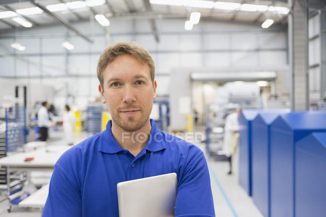 Portrait confident manager with digital tablet in steel factory — Stock Photo