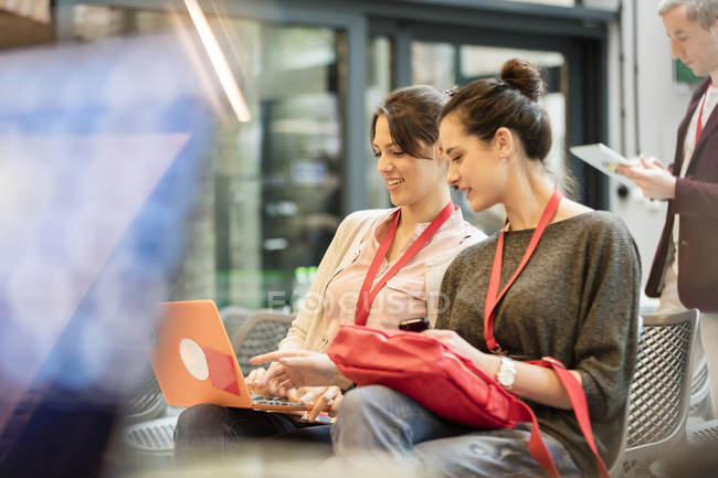 Female college students using laptop — Stock Photo
