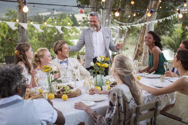 Best man speaking during wedding reception in domestic garden — Stock Photo